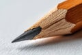 Close view of a sharpened pencil on white paper surface Royalty Free Stock Photo