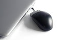 Close View of Silver Laptop and Black Mouse with White Background Royalty Free Stock Photo