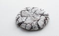 A close view of a single soft tasty chocolate cookie on a white background