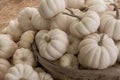 Close view of small pumpkin gourds in rustic wooden basket at fall rural farm market