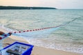 Close view of some blue fishing net floaters on the beach with boat and human while laying nets on the sea Royalty Free Stock Photo