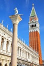 Close view of St Mark`s Campanile, St Theodore of Amasea statue Royalty Free Stock Photo
