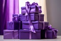 Close view the stack of purple boxes tied with silk ribbon, lying on each other on living. Gift festive selection