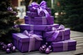 Close view the stack of purple boxes tied with silk ribbon, lying on each other on living. Gift festive selection