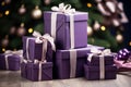Close view the stack of purple boxes tied with silk ribbon, lying on each other on living. Gift festive selection