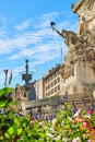 Close view of statues on Soldiers and Sailors Monument next to flowers in Indianapolis, Indiana