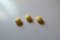 Close view of 3 round yellow pills of xylitol