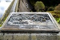 A close view of a tile with information about Laggan Dam construction at River Spean, Scotland