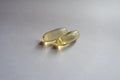 Close view of 2 capsules of fish oil Royalty Free Stock Photo