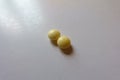 Close view of 2 round yellow pills of xylitol