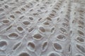Close view of white eyelet embroidery cotton fabric