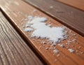 Close view of white bird droppings scattered on brown composite decking planks. The texture of the wood surface shows grain and Royalty Free Stock Photo