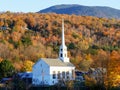 Close view of a white church in vermont and a hill with fall foliage Royalty Free Stock Photo