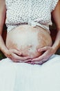 Close view of woman`s pregnant belly