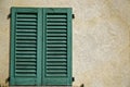 Close vintage window shutter in sunny day, italy style concrete cement wall