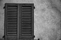 Close vintage window shutter in sunny day, italy style concrete cement wall