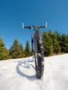 Close wide view to bike stays in snow. Winter snowy mountains