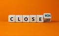 Close won or lost symbol. Turned the wooden cube and changed words Close won to close lost. Beautiful orange background, copy