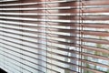 Wooden venetian blind closed on a window