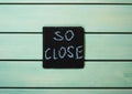 So close words written with chalk on blue wooden background
