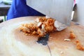 Close up the work of the chef in the kitchen Women are cutting meat, fried chicken on a wooden cutting board. Royalty Free Stock Photo