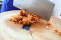 Close up the work of the chef in the kitchen Women are cutting meat, fried chicken on a wooden cutting board. Royalty Free Stock Photo