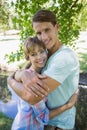 Close young couple standing together in the park smiling at camera Royalty Free Stock Photo