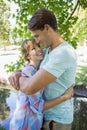 Close young couple standing together in the park smiling at each other Royalty Free Stock Photo