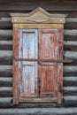 Closed ancient shutters on the windows of a wooden Russian house.