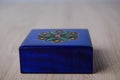 closed antique wooden blue jewelry box on the table Royalty Free Stock Photo