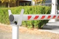 Closed automatic boom barrier on sunny day outdoors, closeup