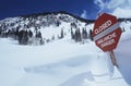 Closed--avalanche danger' sign in snow Royalty Free Stock Photo