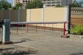 barrier on a city street near a brown fence Royalty Free Stock Photo