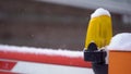 Closed barrier on the road. White-red striped gate, yellow signal light. Winter. Royalty Free Stock Photo