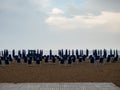 Closed beach parasol at empty seaside coast. Beach in Italy