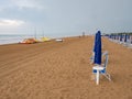 Closed beach parasol at empty seaside coast. Beach in Italy