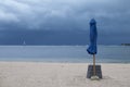 Closed beach umbrella before a storm