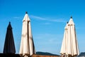 Closed beach umbrellas on blue sky Royalty Free Stock Photo