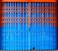 Bi-color retractable folding metallic gate