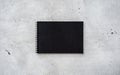 Black Spiral Notebook on a Textured Grey Concrete Surface Royalty Free Stock Photo