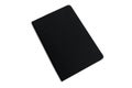 Closed black notepad. Organization in business and study, diary. Isolated on white background. Space for text. Top view Royalty Free Stock Photo