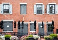 Closed Black Umbrellas by Old Brick Building