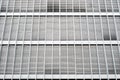 Closed blinds on modern building facade, closed shutters on office exterior