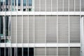 Closed blinds on modern building facade, closed shutters on office exterior