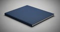 Closed blue book on plain gray background: minimalist design with copy space Royalty Free Stock Photo
