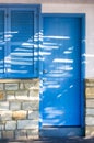 Closed blue door of mediterranean house and closed window