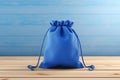 Blue Drawstring Pouch on Wooden Table Royalty Free Stock Photo