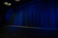 Closed blue theater curtain with dramatic stage lighting Royalty Free Stock Photo