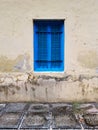 Closed blue window with shutters of an old building or house with a fragment of the floor Royalty Free Stock Photo