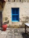 Closed blue window with shutters of an old building or house, view from the courtyard Royalty Free Stock Photo